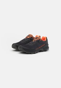 Black trail running shoes with orange accents, featuring a textured upper, reinforced toe, and rugged outsole for grip. Reflective laces included.