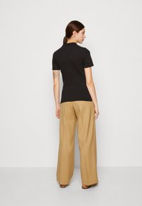 Tommy Hilfiger 1985 SLIM - Polo - black