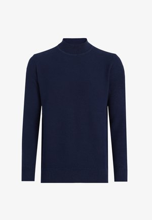 Marineblauwe gebreide trui met een hoge hals, voorzien van een gestructureerd patroon en lange mouwen. Geribde boorden en zoom zorgen voor een aansluitende pasvorm.