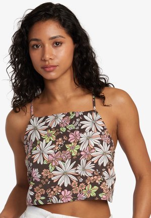 Brown floral crop top featuring white and pink daisies, thin straps, and a soft cotton texture with a relaxed fit.