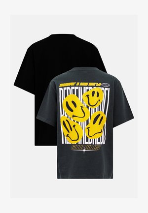 T-shirt oversized em algodão preto e cinza com estampas de rostos sorridentes amarelos e um gráfico de texto nas costas, mangas curtas e um decote crew clássico.