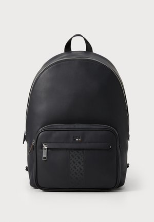 Black leather backpack with a rounded design, front zipper pocket, textured accent panel, and top handle for carrying. Subtle brand logo visible.