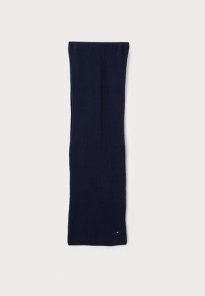 Sciarpa di lana color navy lavorata a maglia con una texture a coste, forma allungata e piccolo logo dettagliato in rosso, bianco e blu nell'angolo in basso.