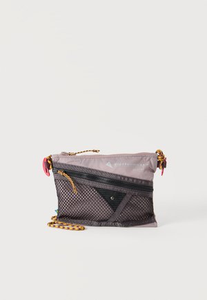 Pequeña bolsa de color lila claro con bolsillo frontal de malla negra, cremallera diagonal, cordón amarillo y rojo, y texto de la marca en la esquina superior derecha.