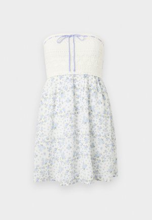 Rihma vaba kleit tekstureeritud valgest korpusest ja helesinisest lillemustrilisest seelikust. Üksikasjadena on peal lilak värv ja seelikul on laiendatud siluett.