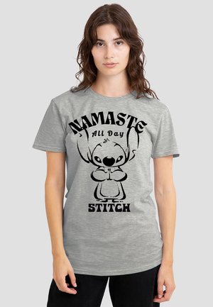 Gray cotton t-shirt featuring a graphic print of a character with claws, hands in a prayer position, and the text "NAMASTE ALL DAY STITCH."