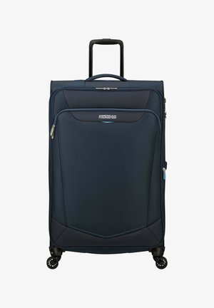 Valise bleu marine avec une finition texturée, poche avant zippée, deux poignées de transport, poignée rétractable et quatre roues multidirectionnelles.