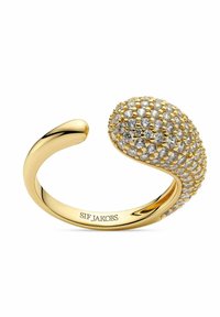 Guldtonad manschett ring med en texturerad, oval topp prydd med små klara kristaller. Graverat varumärke inuti banden.