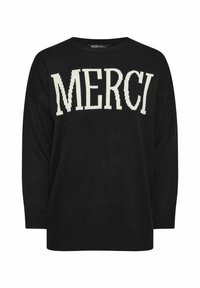 Svart stickad tröja med en stor krämfärgad "MERCI" grafik. Rund halsringning och avslappnad passform med ribbade mudd och fåll.