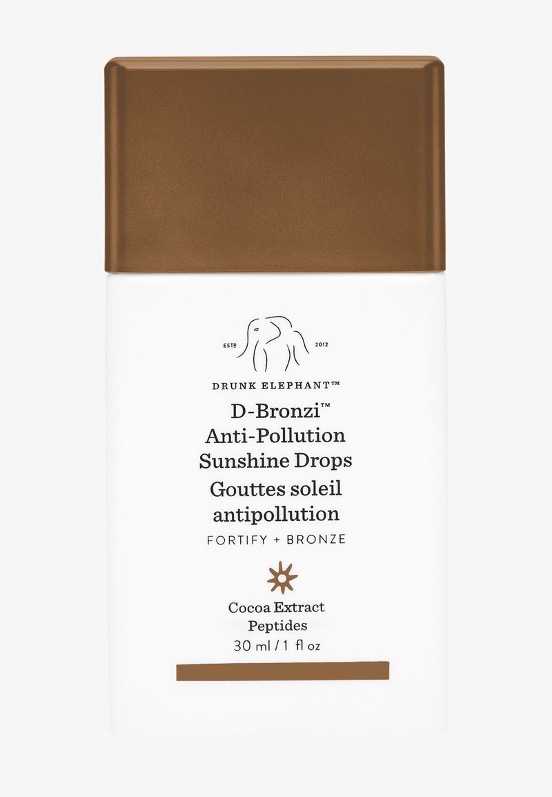 Drunk Elephant D-Bronzi Anti-Pollution Sunshine Drops bottle with bronze cap, containing 30 ml skincare serum with cocoa extract and peptides.