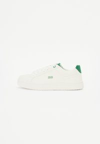 White sneakers with a smooth leather-like exterior, green accent at the heel, textured sole, and subtle brand logo on the side.