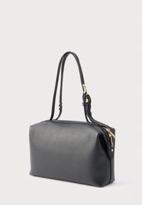 Sort læderhåndtaske med en struktureret form og en glat tekstur. Har en lynlåslukning og detaljer i guldtonet metal.