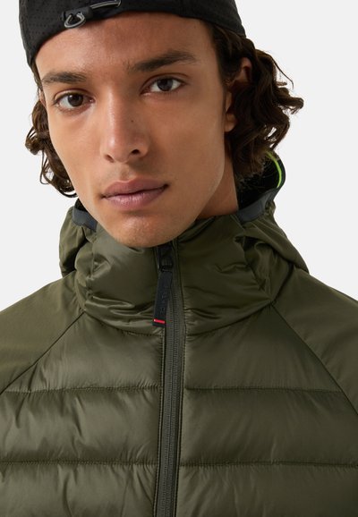 Olive green puffer jacket with a high collar, zip closure, and ribbed texture. Features contrasting black and neon trim details.