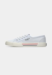 Light blue canvas sneaker with white rubber sole, round toe, five eyelets, and red and navy accent stripes along the side.