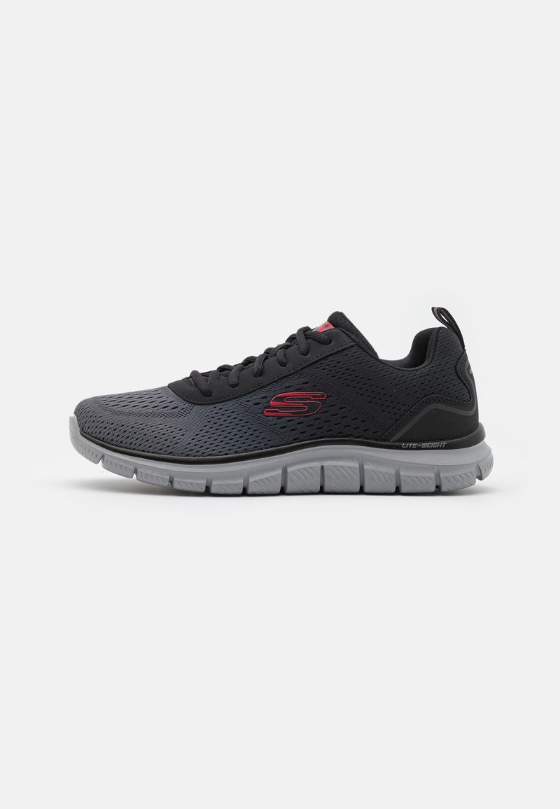 Black and gray athletic shoe with mesh upper, cushioned sole, and red logo detail. Features a rounded toe and flexible design.