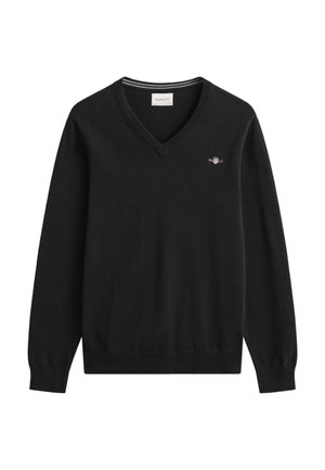 Jersey negro de punto con cuello en V, que presenta un pequeño logo bordado en el pecho y puños y dobladillo acanalados.