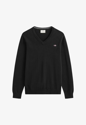 Jersey negro de punto con cuello en V, que presenta un pequeño logo bordado en el pecho y puños y dobladillo acanalados.