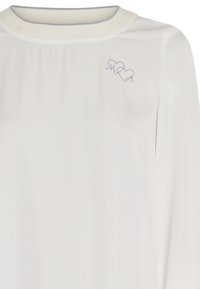 White long-sleeve top featuring a round neckline with a light gray trim and a small embroidered heart and letters "M" and "A" on the chest.