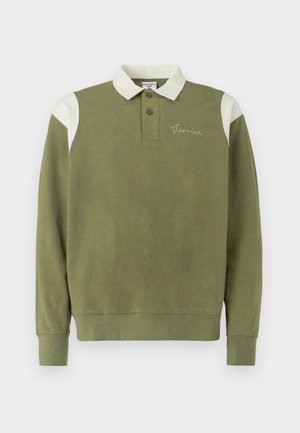 Olive green long-sleeve polo shirt with a white collar and shoulder accents. Features three buttons and embroidered "Terrice" detail.