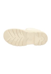 Cream-colored athletic shoe sole with textured tread patterns and rounded edges. Features brand logo within an oval at the midsole.