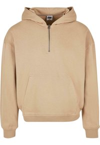 Felpa beige con cappuccio, chiusura con mezza zip, tasca frontale, polsini e orlo a coste. Realizzata in un tessuto morbido con una vestibilità comoda.