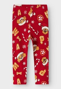 Punased legginsid ribblikangast, millel on joonistatud koomiksikoerad Santa mütsides, kommipulgad, lumekristallid ja luud.