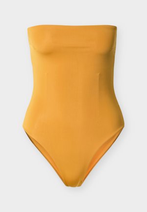 Κίτρινο ολόσωμο μαγιό χωρίς τιράντες με λεία υφή, εφαρμοστή σχ εδίαση και ψηλές ανοίγματα στα πόδια. Χωρίς ορατά σχέδια ή μεταλλικά στοιχεία.