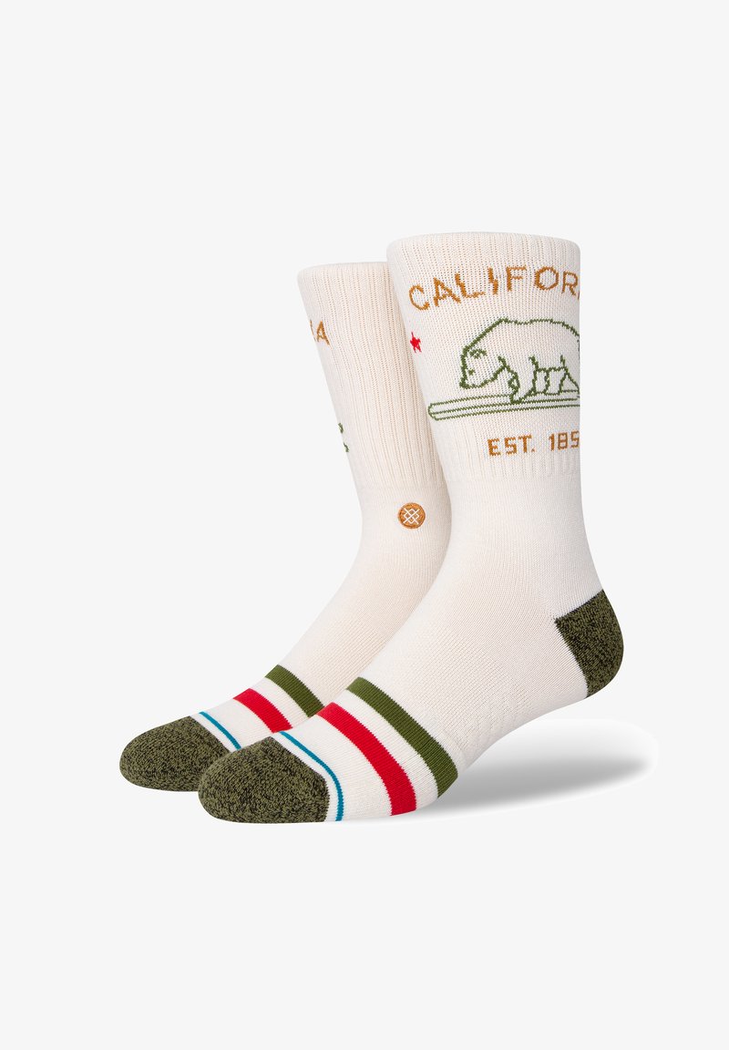 Knee-high socks with a cream base, green bear graphic, "CALIFORNIA" text, and colored stripes in red, green, and blue at the toe and cuff.