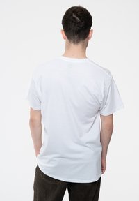 White cotton t-shirt with short sleeves, crew neckline, and a relaxed fit. Viewed from the back, no visible designs or patterns.
