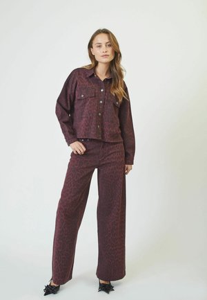 Burgundy denim jacket with leopard print, featuring two chest pockets and button closure, paired with matching wide-leg pants.