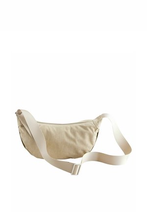Sac bandoulière en velours côtelé beige avec bandoulière réglable et fermeture éclair, conçu pour un usage décontracté.