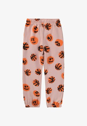 Jasnoróżowe spodnie dresowe z czarnymi i pomarańczowymi wzorami koszykówki i uśmiechniętej buźki, wyposażone w elastyczny pas i zwężane mankiety.