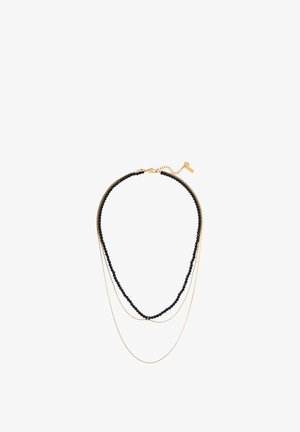 Kolme kihilist kaelakee, mis sisaldab mustade helmed, kahte kuldset ahelat, sulgemise ja pikkuse reguleerimise võimalust.