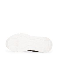 Shoe sole with a textured black surface and a white rubber outsole. Distinctive groove pattern for traction and flexibility.