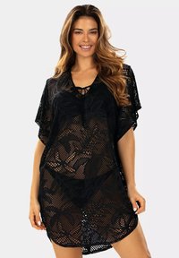 Czarny szydełkowy okrycie z dekoltem w serek i krótkimi rękawami, z detalem sznurówki i floralnym wzorem na całej powierzchni. Lekki i przezroczysty.