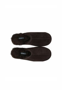 Brune ruskindsslippers med en fyldig, mørk pelsforing. Har et lukket bagdesign og synlige syninger. Brandlogo indeni.