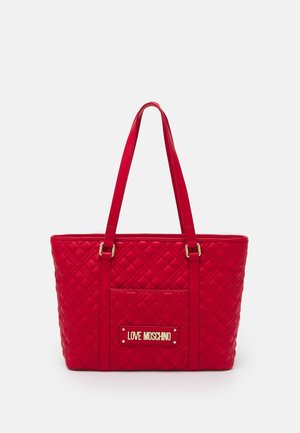 Red quilted tote bag with long handles, front pocket, and gold "Love Moschino" logo plaque.