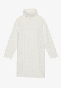 Vestido de punto grueso con cuello alto en color crema, que presenta mangas largas y un dobladillo acanalado para dar textura. La tela suave ofrece calidez y comodidad.