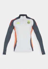 Long-sleeve athletic top in white, with dark gray sleeves and orange side accents. Features a zip neck and brand logo on the chest.
