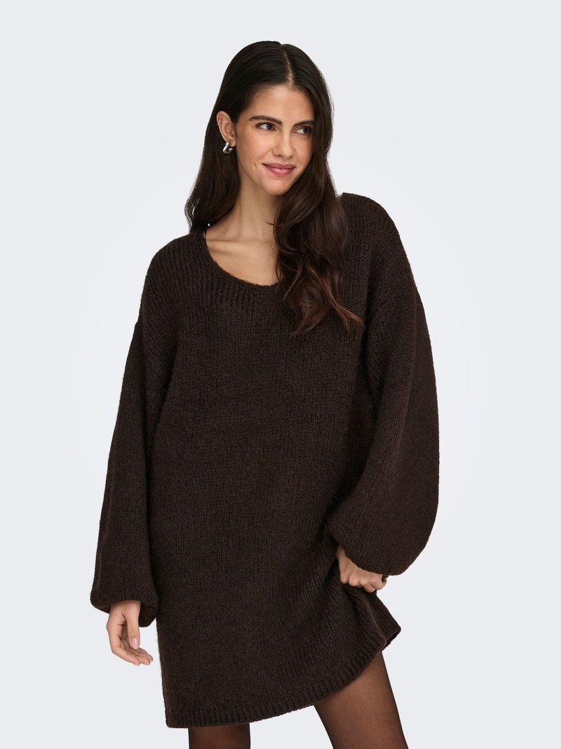 Brown oversized knit sweater dress with a round neckline and long sleeves. Textured fabric and ribbed hem detail.