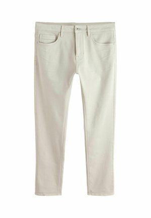 Beige Herren-Skinny-Jeans mit fünf Taschen, Gürtelschlaufen, Knopfverschluss und sichtbaren Nähten, dargestellt vor weißem Hintergrund.