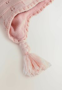 Textil tricotat moale de culoare roz, cu un interior pufos, având o ciucurel împletit la vârf și margini ondulate. Textura este călduță și primitoare.