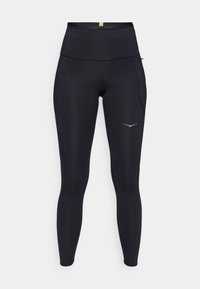 Leggings de sport noirs avec une taille haute. Fabriqués en matériau extensible, dotés de deux poches latérales et d'un détail de logo réfléchissant.