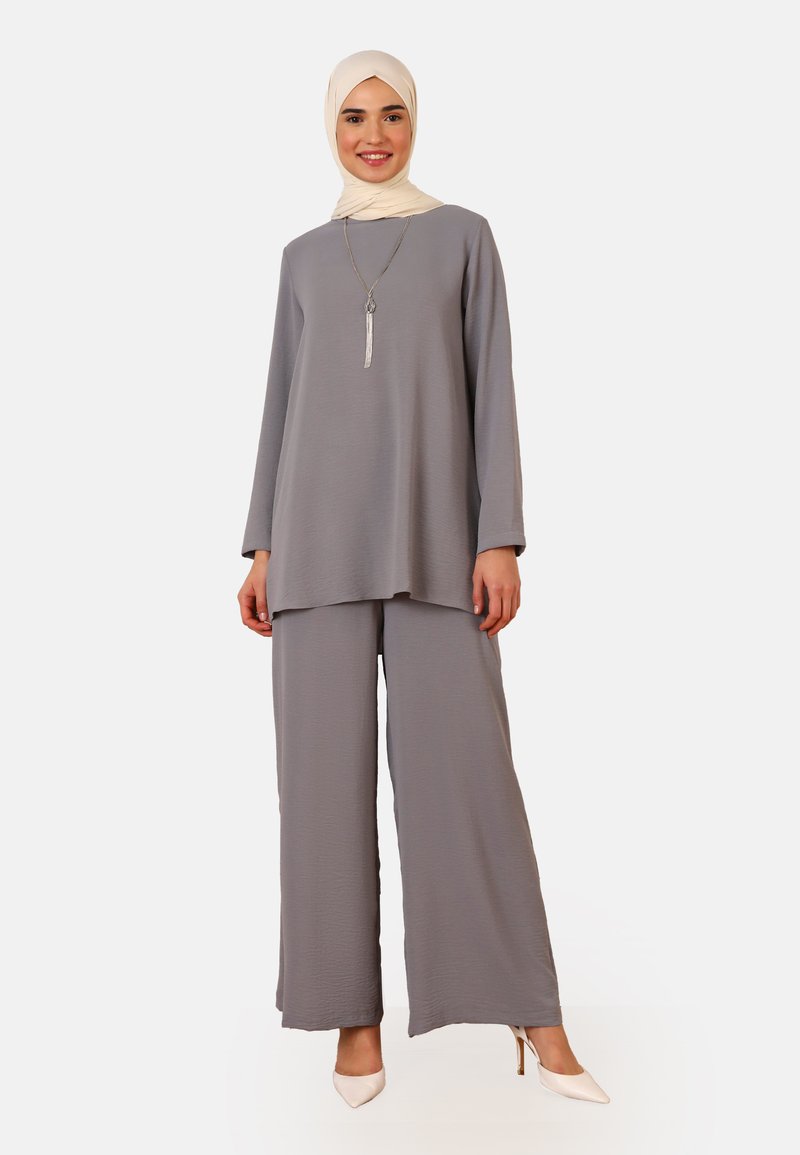 Gray two-piece outfit featuring a long-sleeve top and wide-leg trousers made from a lightweight fabric, complemented by a cream-colored hijab.