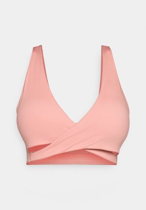 Roza, bezšavna sportska grudnjak s širokim trakama i dizajnom u obliku slova V. Ima obavijeni prednji dio i teksturirani pojas za podršku. Glatki materijal.