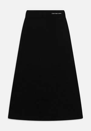 Jupe trapèze noire en tissu doux, dotée d'une large ceinture élastique avec la marque "Calvin Klein Jeans" en haut.