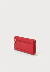 Red zippered wallet with a textured surface, featuring a back pocket, gold-tone zipper, and sleek rectangular shape.