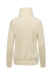 Pullover beige a maniche lunghe con colletto alto che presenta sottili motivi floreali e fogliari su uno sfondo finemente rigato.