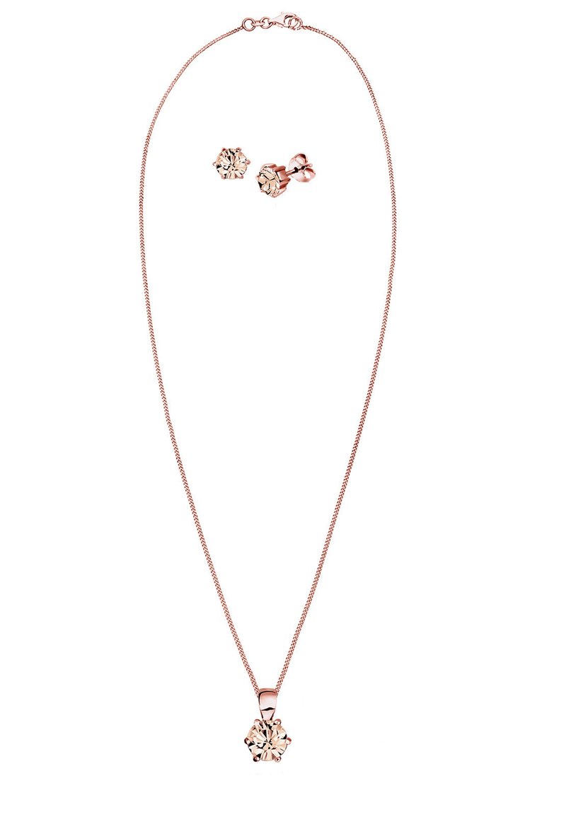 Halskette aus Roségold mit einer dünnen Kette und einem floralen Anhänger, der einen zentralen transparenten Stein zeigt, begleitet von passenden blumenförmigen Ohrsteckern.