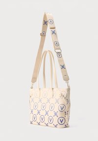 Lys beige mulepose med lilla cirkulære og blomsteragtige mønstre. Har to håndtag, en justerbar rem og guldfarvede metaldetaljer.